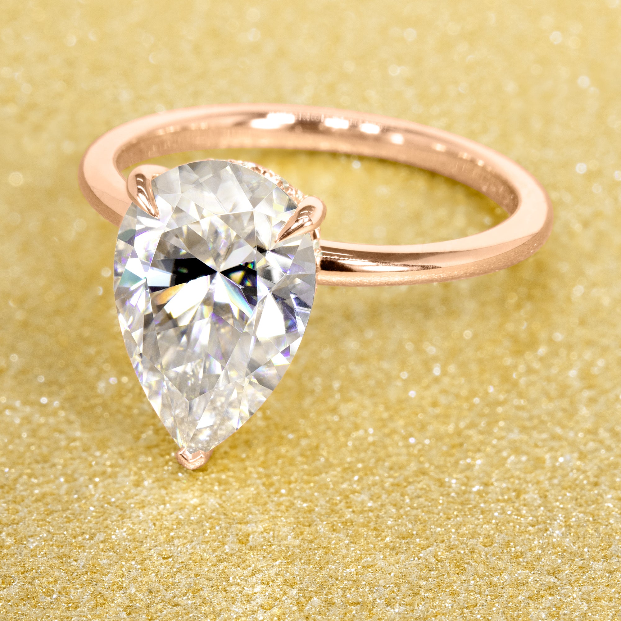 The Adara 3.5ct Pear-shaped Moissanite Hidden Halo Engagement Ring is a classic look with an elegant twist complemented by Lab Diamonds handcrafted in 14K Gold, 18K Gold, or Platinum by Earthena Jewelry of Beverly HIlls