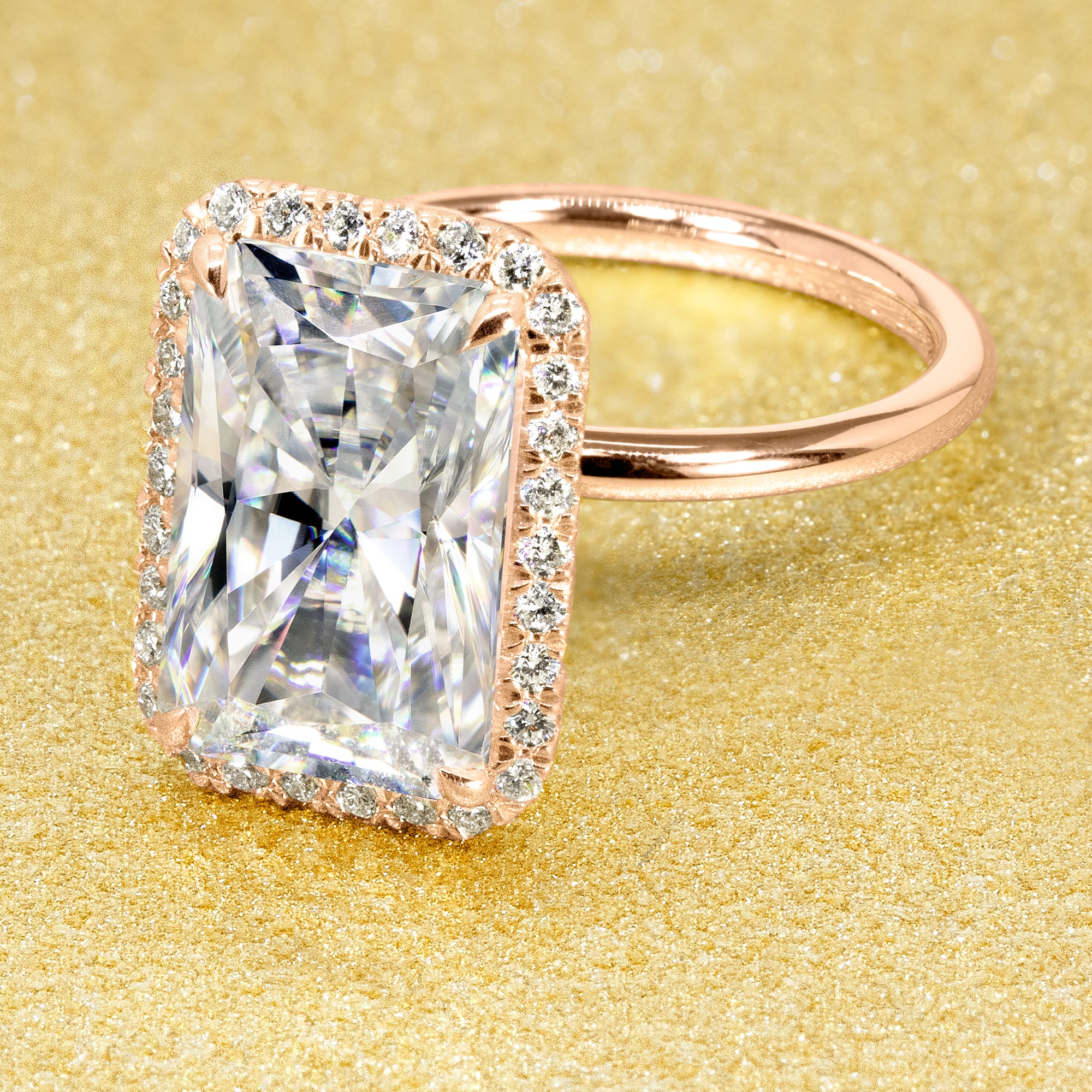 The Adara Elongated Radiant-cut Moissanite Halo Engagement Ring is a classic look with an elegant twist complemented by Lab Diamonds handcrafted in 14K Gold, 18K Gold, or Platinum by Earthena Jewelry of Beverly Hills.