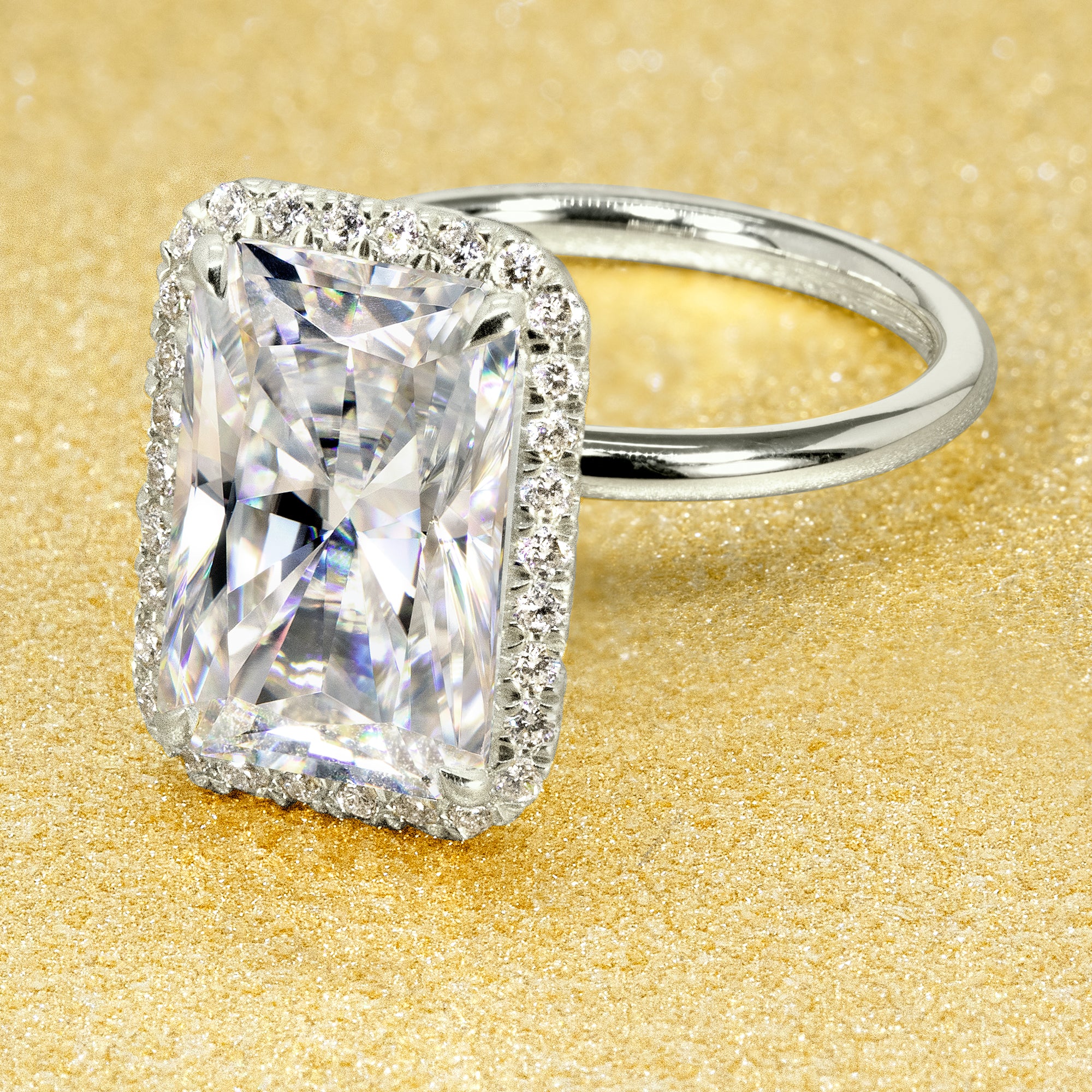 The Adara Elongated Radiant-cut Moissanite Halo Engagement Ring is a classic look with an elegant twist complemented by Lab Diamonds handcrafted in 14K Gold, 18K Gold, or Platinum by Earthena Jewelry of Beverly Hills.