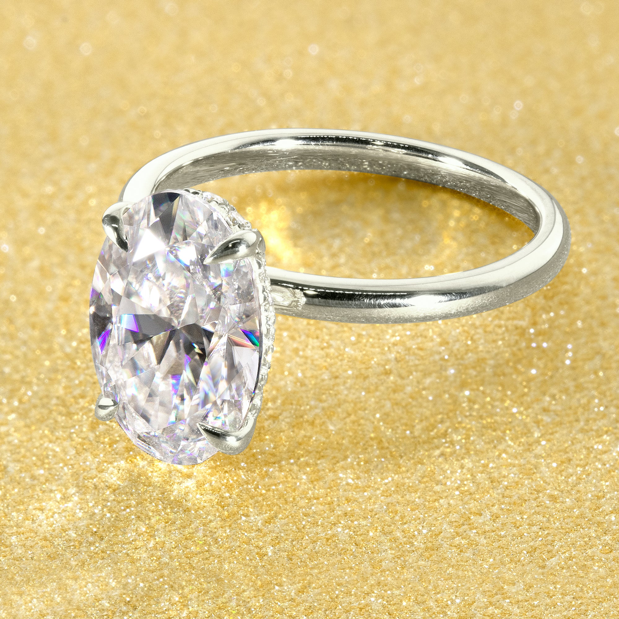 The Adara Elongated Oval-cut Moissanite Hidden Halo Engagement Ring is a classic look with an elegant twist complemented by Lab Diamonds handcrafted in 14K, Gold, 18K Gold, or Platinum by Earthena Jewelry of Beverly Hills.