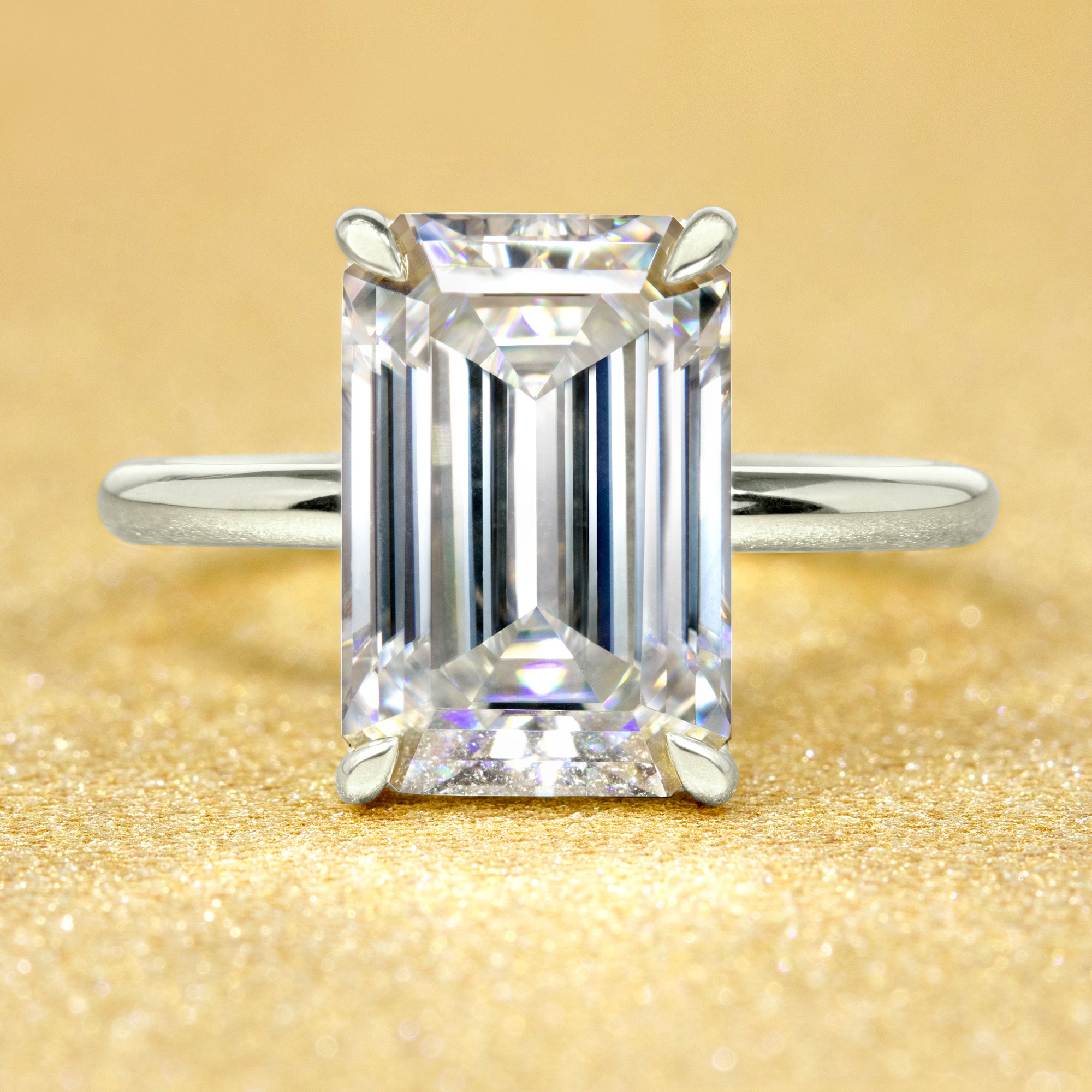 The Adara, 5ct Elongated Emerald-Cut Lab-Grown Diamond Hidden Halo Engagement Ring in 14K Gold, 18K Gold, or Platinum by Earthena Jewelry of Beverly Hills.