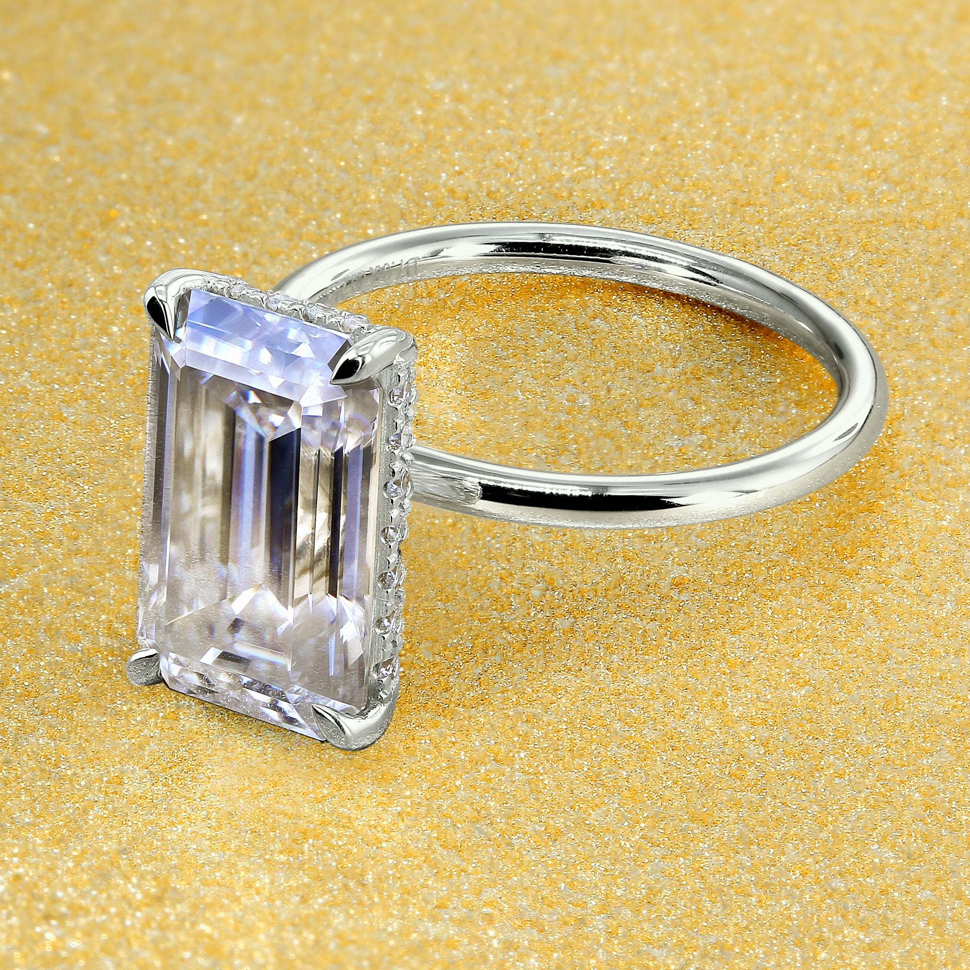 Classic Ariela 5.5ct Elongated Emerald-cut Moissanite Halo Solitaire Engagement ring complemented by Lab Diamonds handcrafted in 14K Gold, 18K Gold, or Platinum by Earthena Jewelry of Beverly Hills.