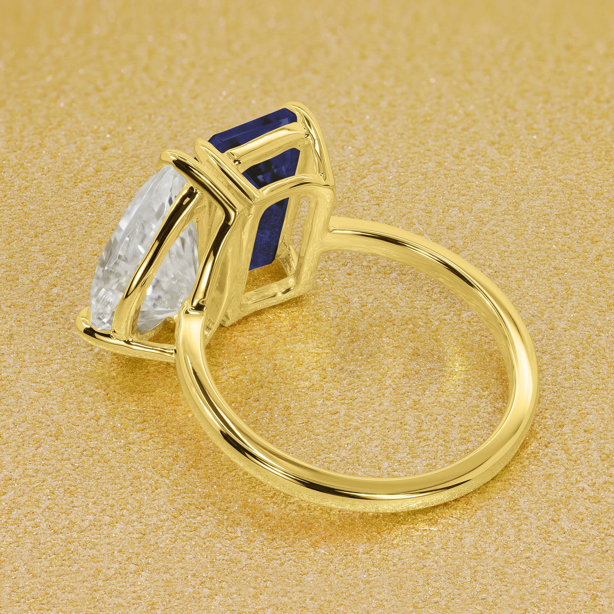 This timeless "Toi et Moi" Gemini Sleek engagement ring showcases a captivating combination of a 3.75ct lab-grown elongated emerald-cut blue sapphire and a 2.25ct pear-shaped moissanite in a minimalistic plain gold band setting. The ring is available in 14K Gold, 18K Gold, or Platinum by Earthena Jewelry of Beverly HIlls.