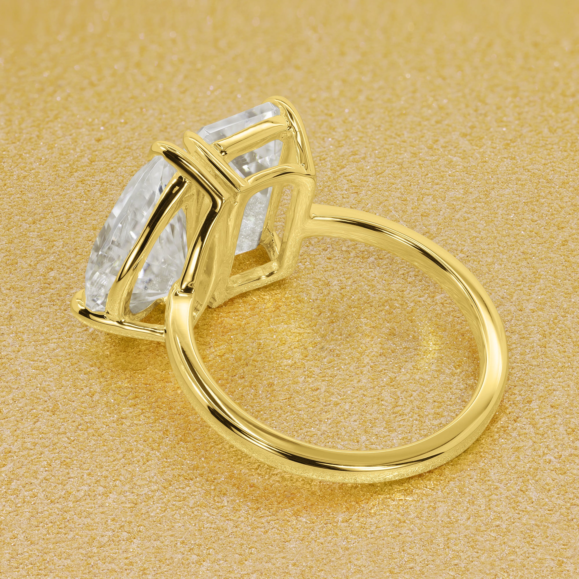 This timeless "Toi et Moi" Gemini Sleek engagement ring showcases a captivating combination of a 3.75ct elongated emerald cut and a 2.25ct pear-shaped moissanite in a minimalistic plain gold band setting. The ring is available in 14K Gold, 18K Gold, or Platinum by Earthena Jewelry of Beverly Hills.