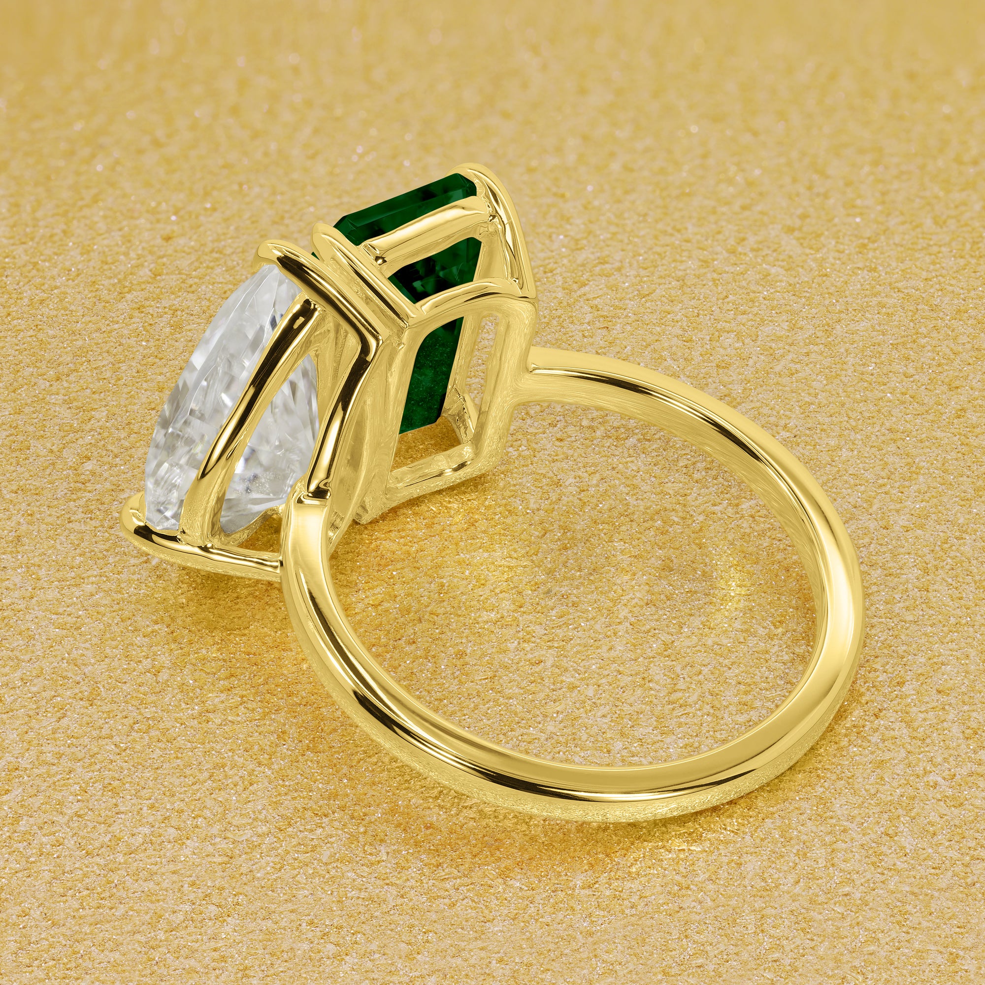 This timeless "Toi et Moi" Gemini Sleek engagement ring showcases a captivating combination of a 3.75ct lab-grown elongated green emerald and a 2.25ct pear-shaped moissanite in a minimalistic plain gold band setting. The ring is available in 14K Gold, 18K Gold, or Platinum by Earthena Jewelry of Beverly Hills.