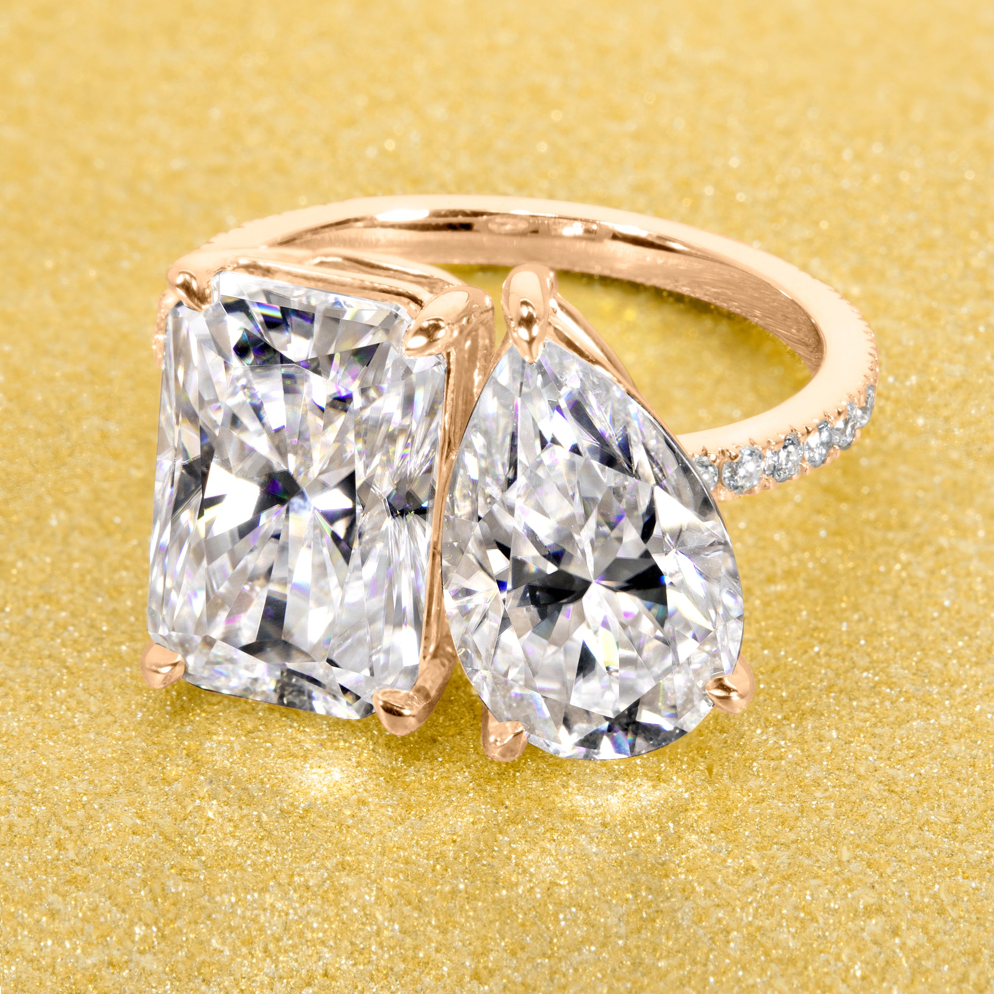 This timeless "Toi et Moi" Gemini engagement ring showcases a captivating combination of a 3.75ct elongated radiant-cut and a 2.25ct pear-shaped moissanite, styled with lab-grown side diamonds. The ring is available in 14K Gold, 18K Gold, or Platinum by Earthena Jewelry of Beverly HIlls.