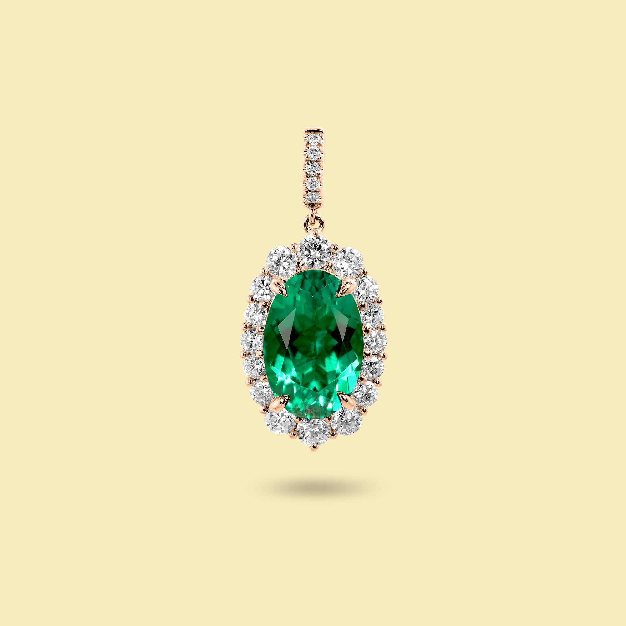 Gloria 3ct Oval-Cut Colombian Green Lab-Grown Emerald Halo Charm Pendant in 14K Gold, 18K Gold, or Platinum by Earthena Jewelry of Beverly Hills.