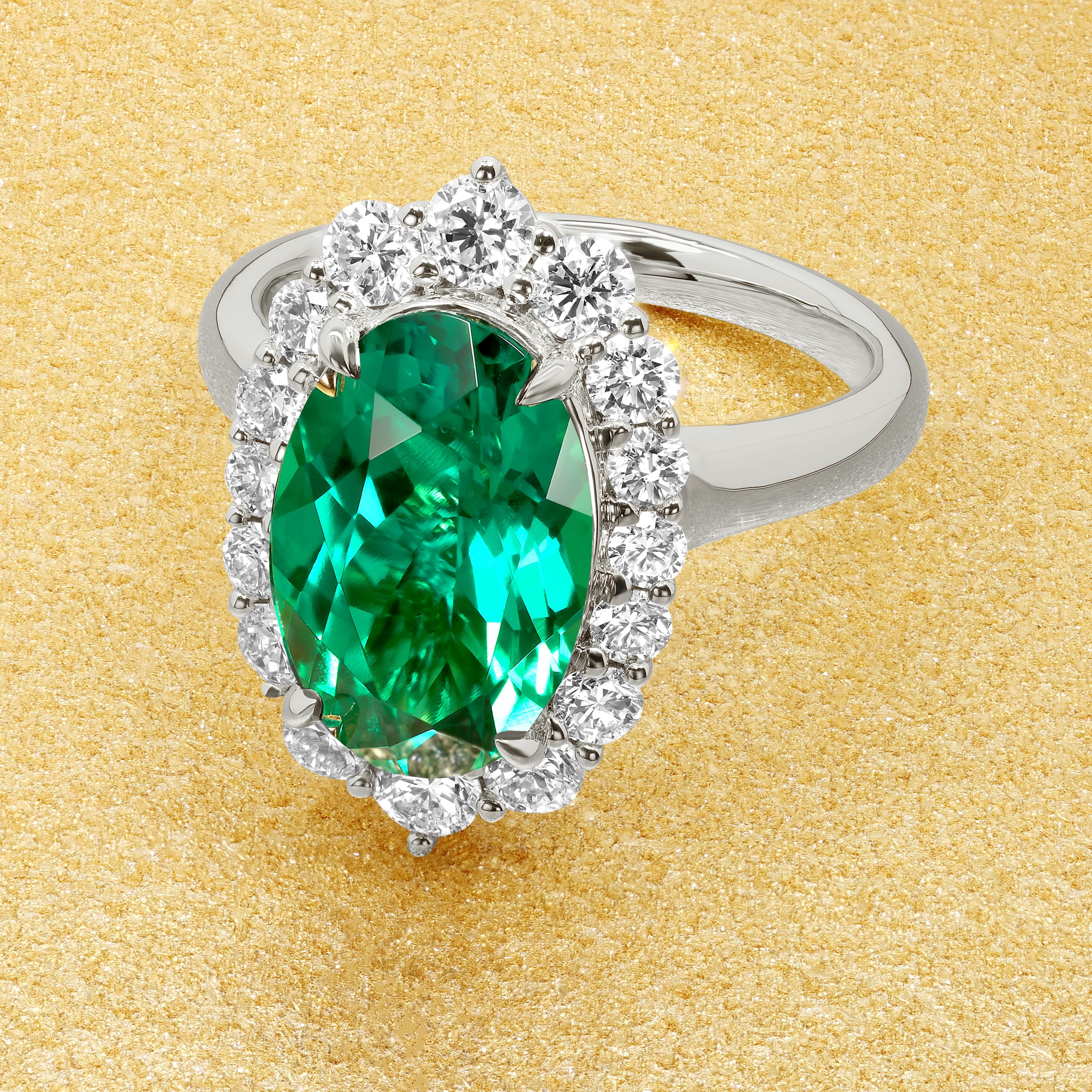 Gloria 3ct Elongated Lab-grown Oval-cut Vivid Green Emerald Halo Cathedral Engagement Ring in 14K Gold, 18K Gold, or Platinum by Earthena Jewelry of Beverly Hills.