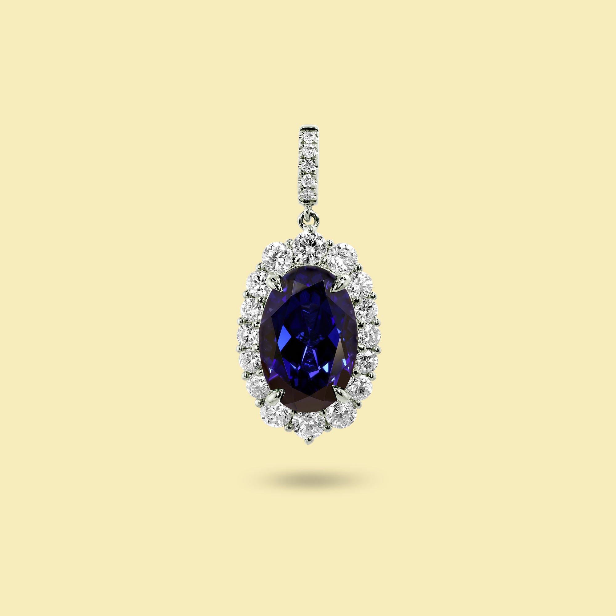 Gloria 4ct Elongated Lab-Grown Oval-Cut Blue Sapphire Halo Charm Pendant in 14K Gold, 18K Gold, or Platinum by Earthena Jewelry of Beverly Hills.