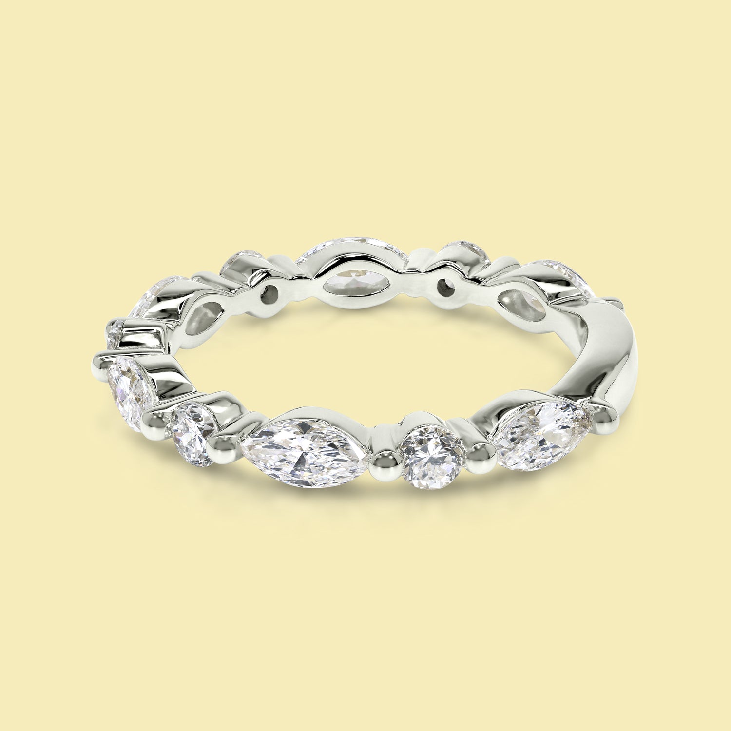 This Grace Floating Marquise and Round Brilliant-cut Diamond Semi-eternity Band is Handcrafted in 14K gold, 18K gold, or Platinum by Earthena Jewelry in Beverly Hills.