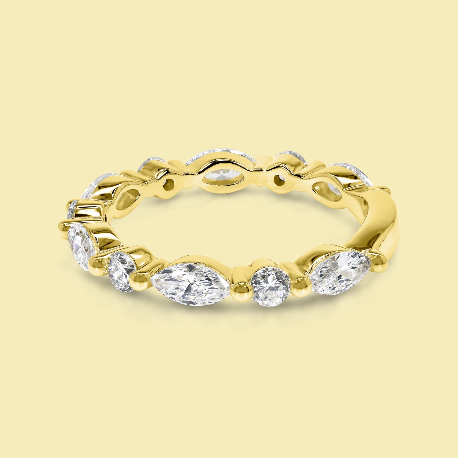 This Grace Floating Marquise and Round Brilliant-cut Diamond Semi-eternity Band is Handcrafted in 14K gold, 18K gold, or Platinum by Earthena Jewelry in Beverly Hills.