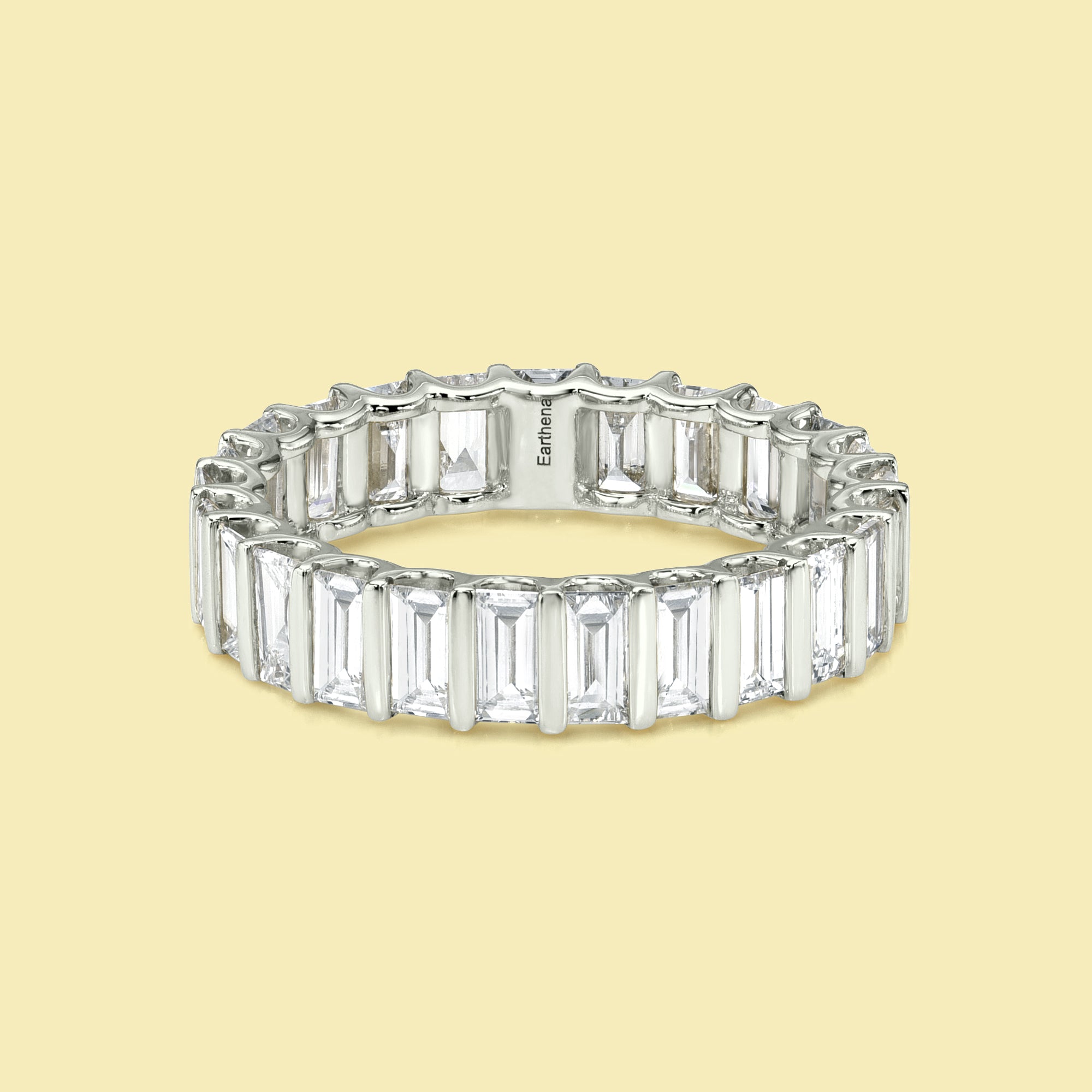 The Ivy Baguette-cut Diamond Channel Eternity Band is handcrafted in 14K gold, 18K gold, and Platinum handcrafted in Los Angeles by Earthena Jewelry