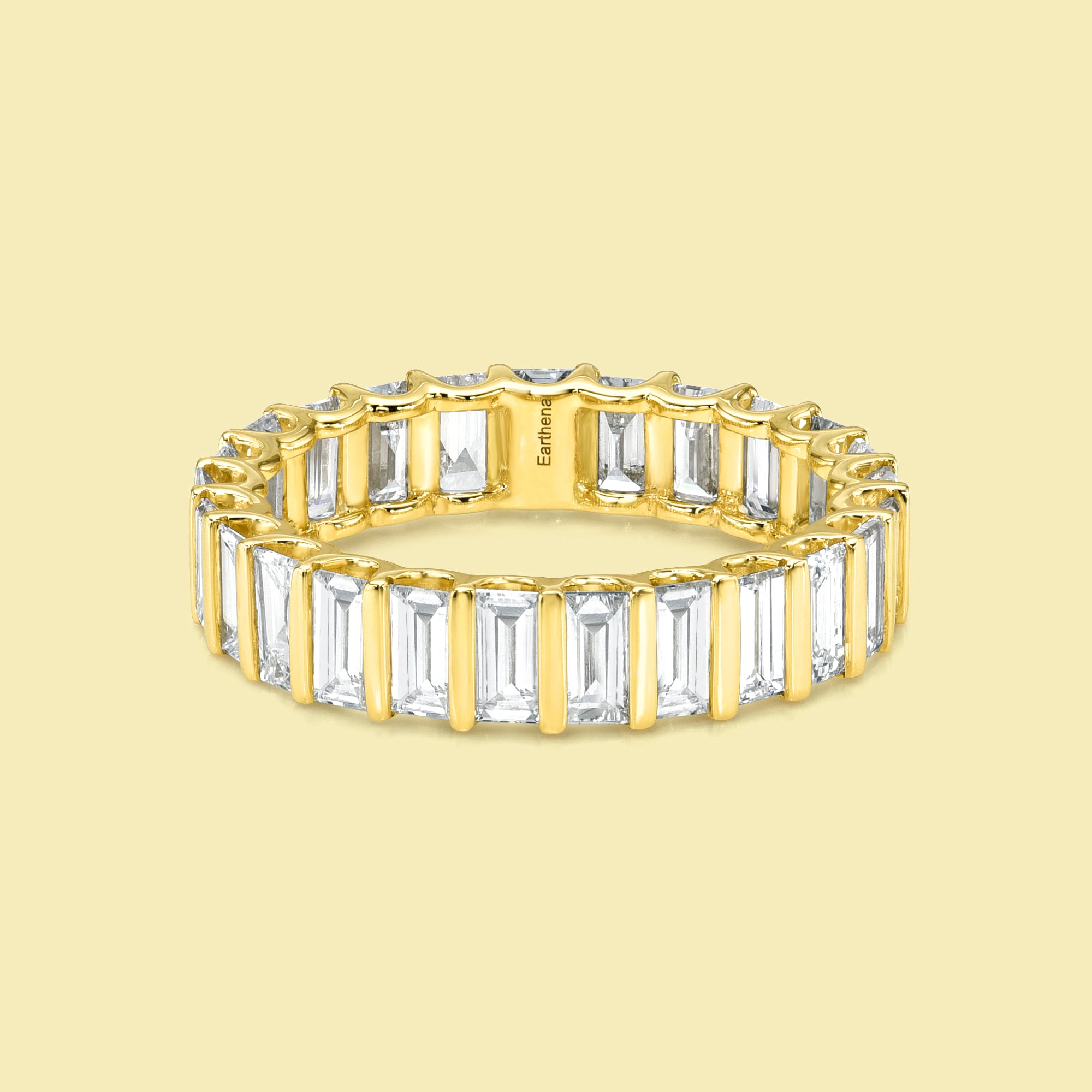 The Ivy Baguette-cut Diamond Channel Eternity Band is handcrafted in 14K gold, 18K gold, and Platinum handcrafted in Los Angeles by Earthena Jewelry