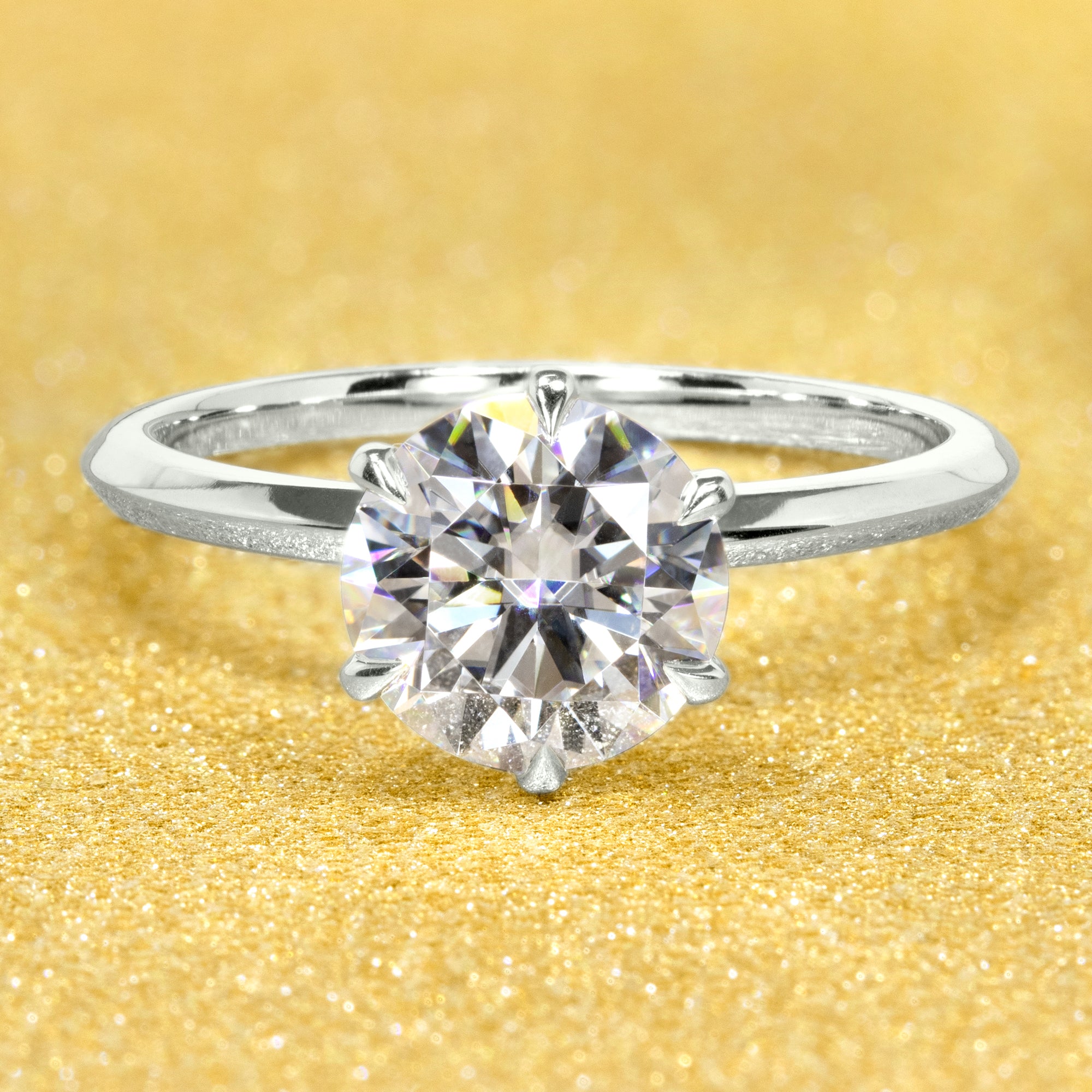 The Lexi, 2ct Round Brilliant-Cut Lab-Grown Diamond Knife-Edge Solitaire Engagement Ring in 14K Gold, 18K Gold, or Platinum by Earthena Jewelry of Beverly Hills.