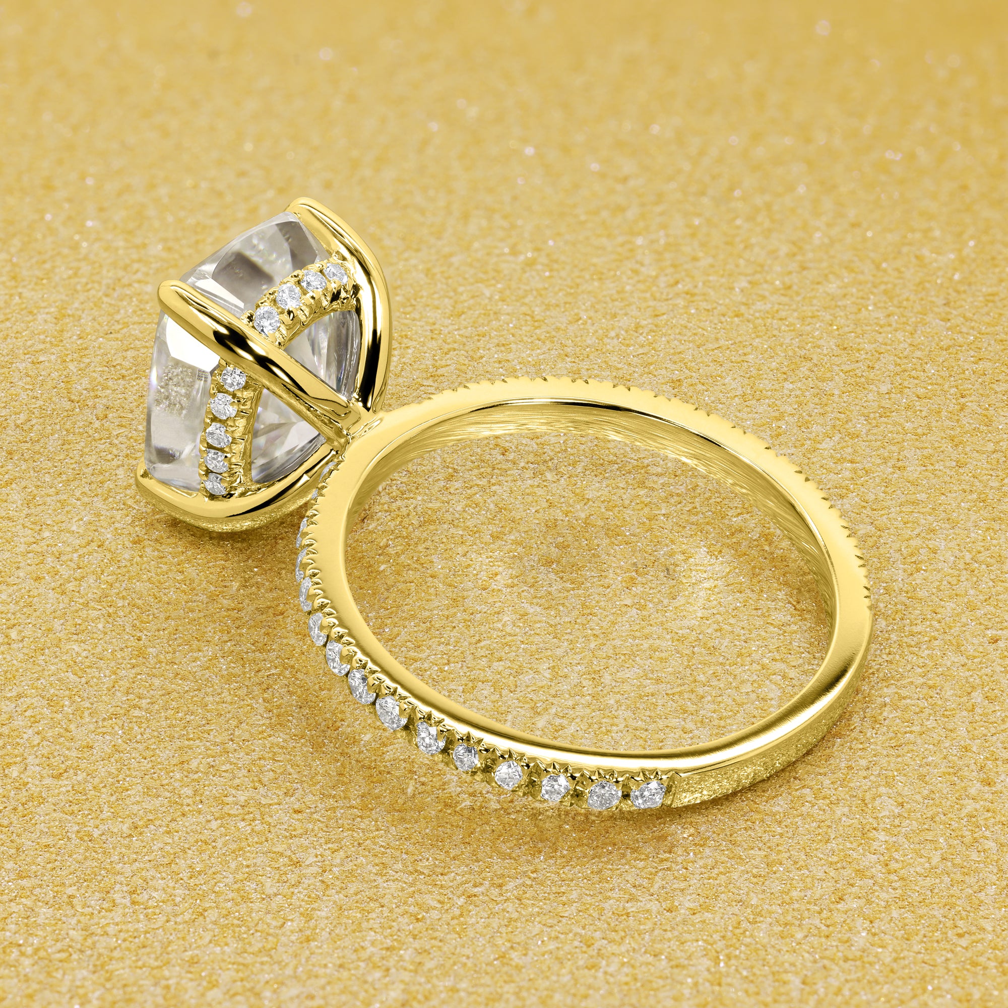 The Stella Elongated Brilliant-cut Cushion-cut Pave band Hidden Halo Moissanite Engagement Ring is a classic look with an elegant twist complemented by Moissanite stones handcrafted in 14K Gold, 18K Gold, or Platinum handcrafted in Los Angeles by Earthena Jewelry..