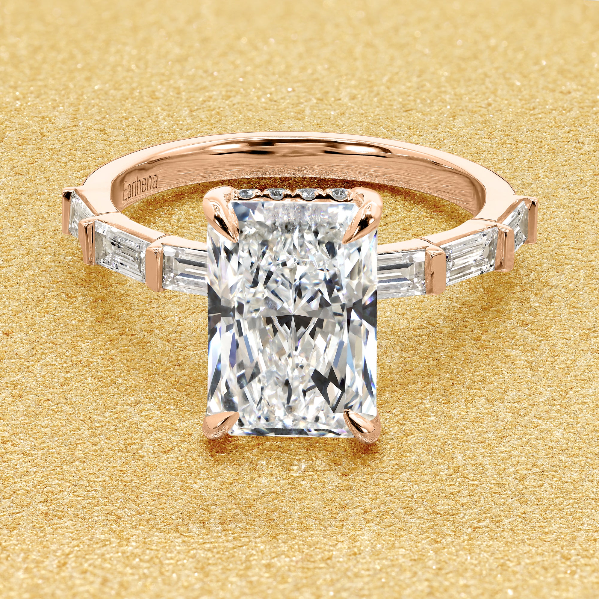 The Taylor, 3ct Elongated Radiant-Cut Lab-Grown Diamond Hidden Halo Baguette Engagement Ring in 14K Gold, 18K Gold, or Platinum by Earthena Jewelry of Beverly Hills.