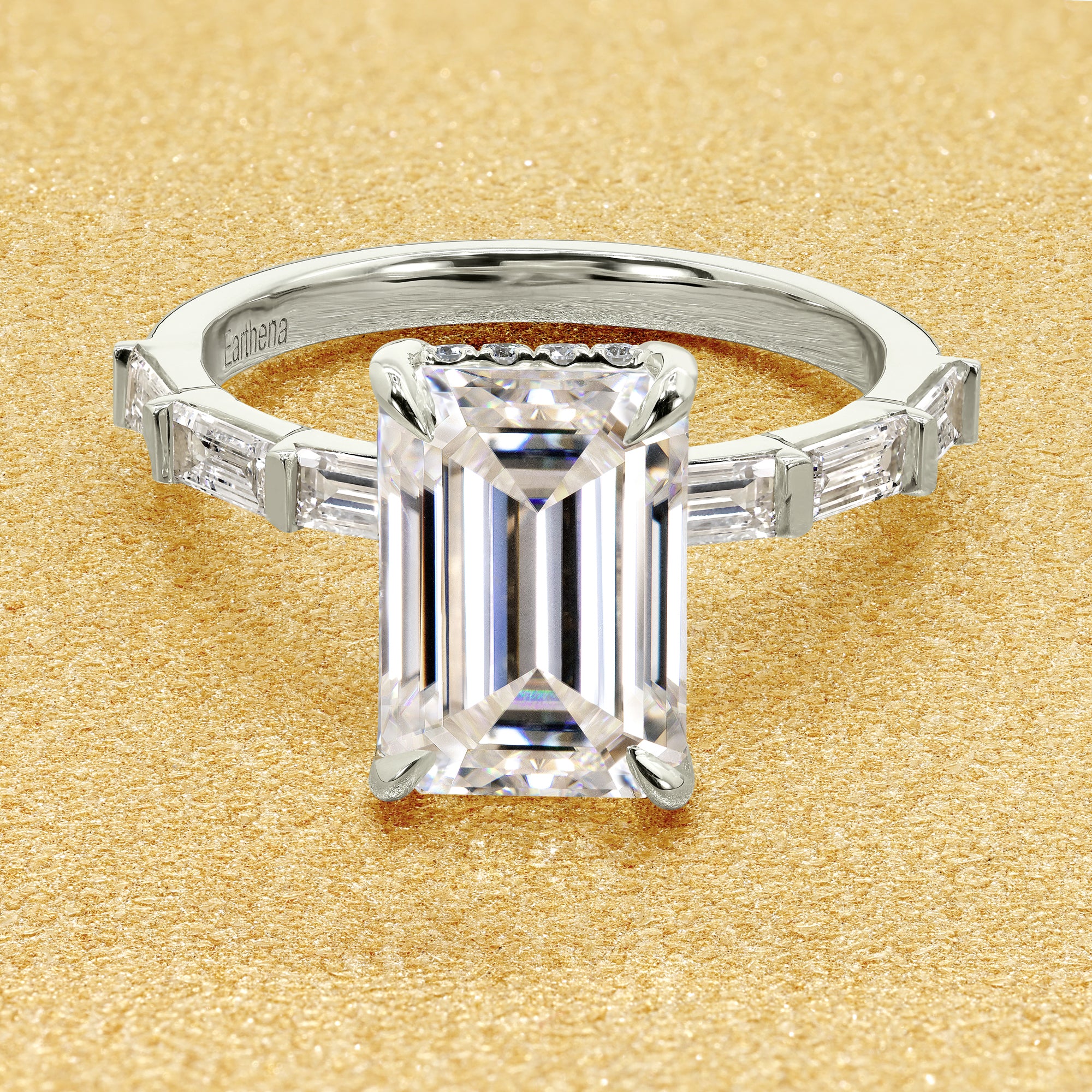 The Taylor, 3ct Elongated Emerald-Cut Lab-Grown Diamond Hidden Halo Baguette Engagement Ring in 14K Gold, 18K Gold, or Platinum by Earthena Jewelry of Beverly Hills.