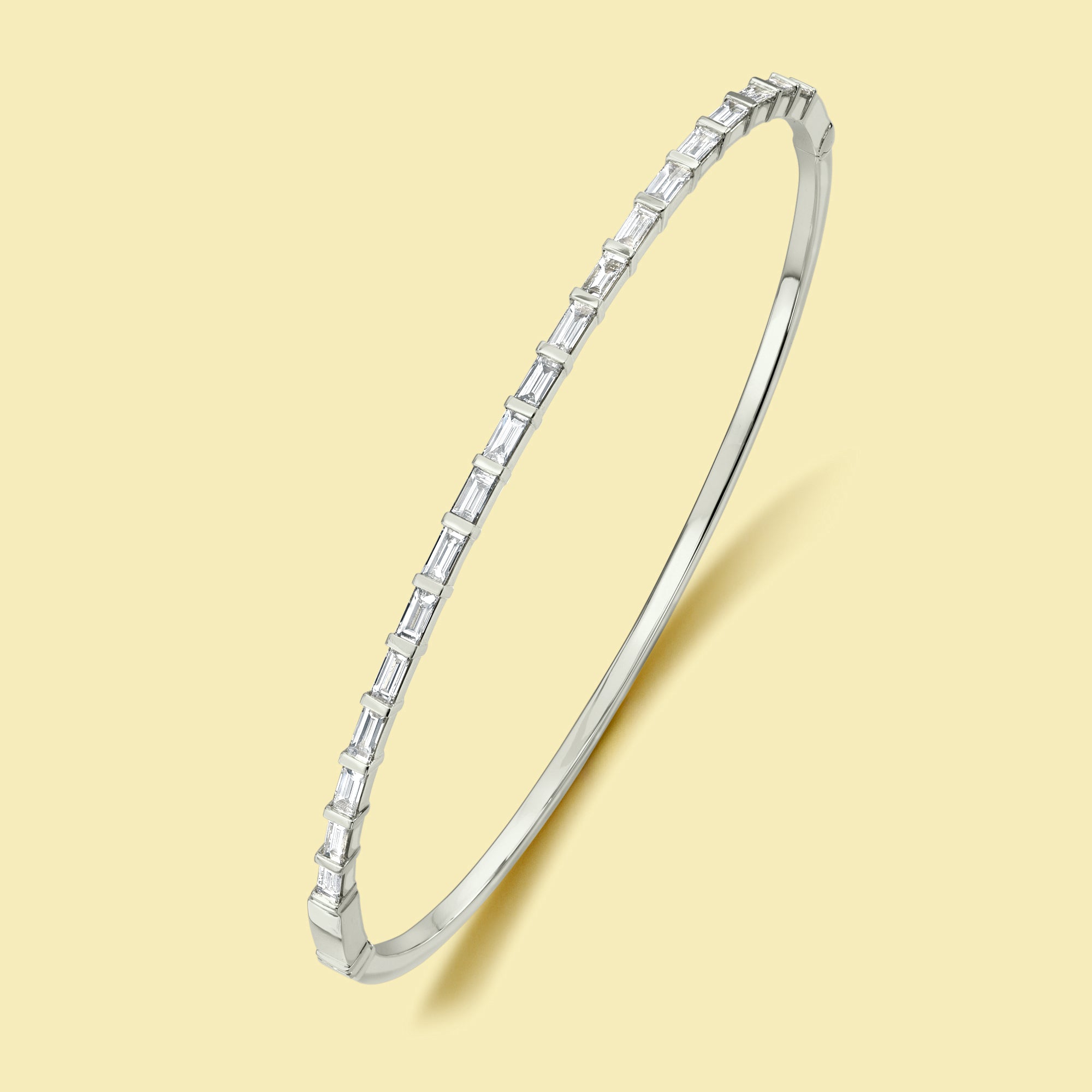 The Taylor, East-West Baguette Diamond Bangle is handcrafted in 14K gold, 18K gold, or Platinum handcrafted in Los Angeles by Earthena Jewelry.