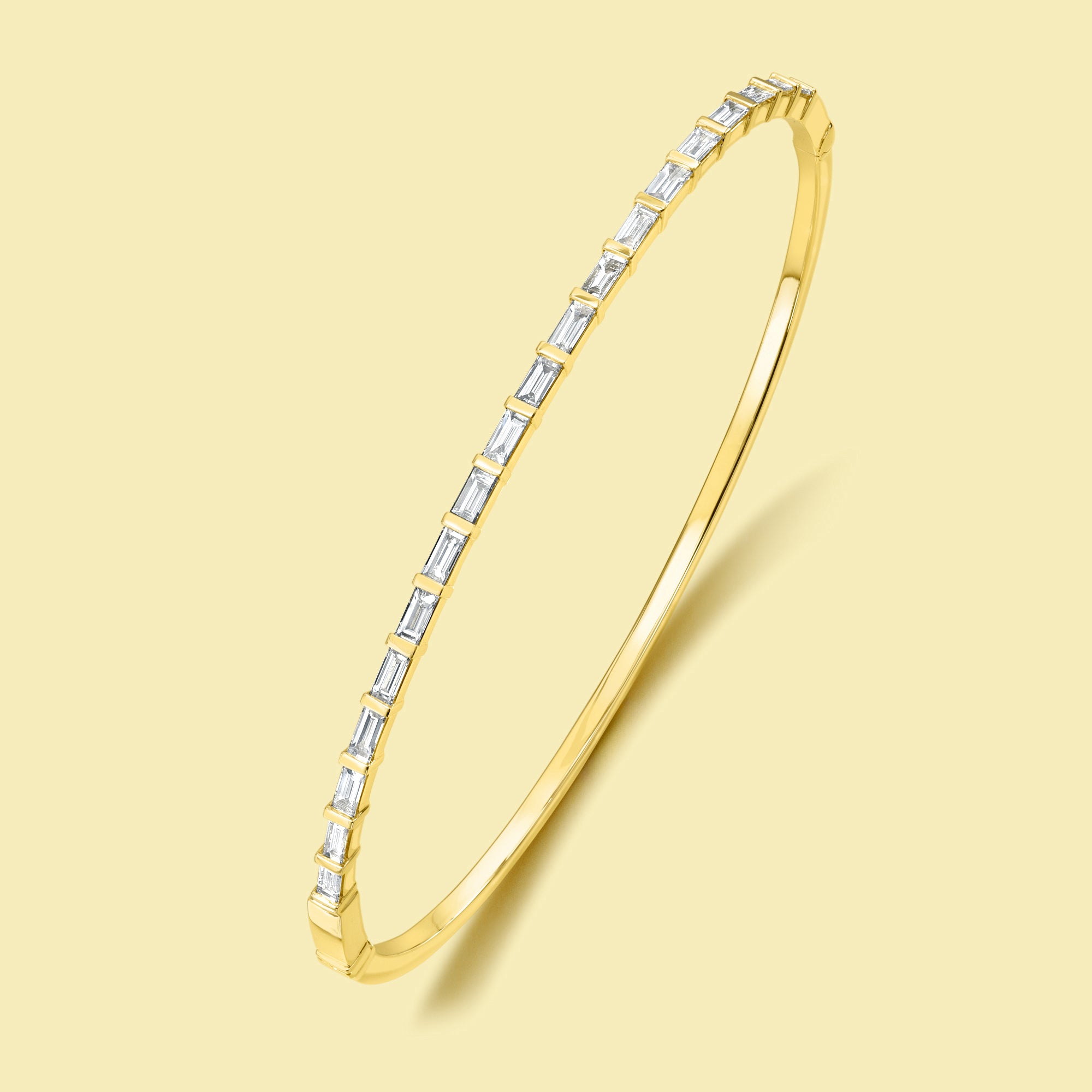 The Taylor, East-West Baguette Diamond Bangle is handcrafted in 14K gold, 18K gold, or Platinum handcrafted in Los Angeles by Earthena Jewelry.